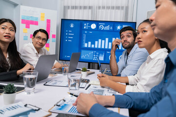 Fototapete - Analyst team utilizing BI Fintech to analyze financial data at table in meeting room. Businesspeople analyzing BI dashboard power for business insight and strategic marketing planning. Prudent