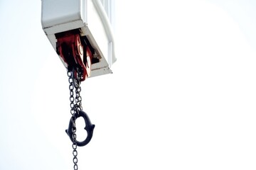 Aufkleber - A crane hangs precariously from the side of a building, highlighting urban infrastructure and construction