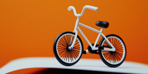 Poster - A toy bike placed on top of an open book, perfect for a child's play or storytelling scene