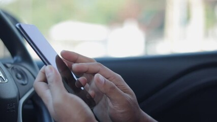 Poster - Young man hand using app on smartphone in car for lock or unlock. The concept for using technology, shopping online, message, search, email business. Internet social network browsing, phone addiction.