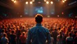 © miss irine - Man giving a speech in front of large audience in a hall. Speaker is focused on presentation. Large crowd listens attentively. Indoor event. Possible conference or seminar.