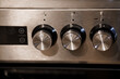 © Galka3250 - Close-Up of Stainless Steel Oven Control Knobs with Digital Display