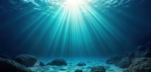 Poster - Underwater scene shows sunlight beams penetrating deep blue water. Ocean floor with rocks, sand. Vibrant blue color. Natural beauty of tropical seascape. Sun rays illuminate bottom. Tranquil aquatic