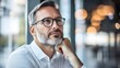 © Berkah - Thoughtful mature man in glasses contemplating indoors