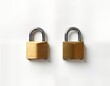 © miss irine - Two brass padlocks displayed against plain white backdrop. One lock open, one closed. Symbolize security, protection business concept. Image perfect for use in stock photos for diverse topics like