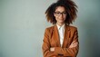 © miss irine - Confident young black businesswoman wears trendy brown blazer, glasses. Stylish female executive with curly hair smiles confidently. Pro portrait empowerment, leadership qualities. Focus on success,