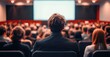 Business Speaker Delivering Talk at Conference with Engaged Audience in Lecture Hall