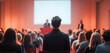 © Margarita - Audience at Business Conference Listening to Speaker at Podium in Modern Lecture Hall