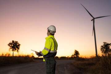 Aufkleber - Engineer man working with tablet at windmill farm Generating electricity clean energy. Wind turbine farm generator by alternative green energy.