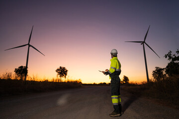 Aufkleber - Engineer man working with tablet at windmill farm Generating electricity clean energy. Wind turbine farm generator by alternative green energy.