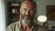 © Business Pics - Smiling relaxed mature older bearded hipster man looking at camera. Happy handsome confident middle aged 50s male professional, standing at home office posing indoors for close up headshot portrait.