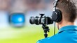 © EvgeniiasArt - Male cameraman captures live sports event with professional equipment