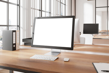 Poster - office desk with computer monitor displaying blank white screen in modern workspace. 3d rendering