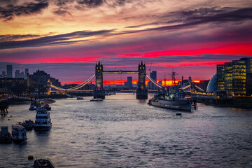 Wall Mural - Beautiful sunrise view of the iconic Tower Bridge in London, England, with red and golden clouds