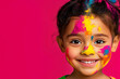 © Tanya - Cute and cheerful Indian girl covered in Holi colors, standing against a vibrant pink background with space for text. Banner.