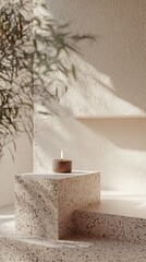 Lit Candle in Terracotta Container on Textured Pedestal with Greenery