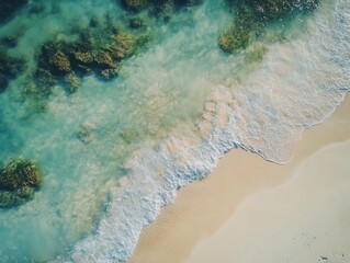  Aerial view of a serene beach with clear turquoise water and gentle waves lapping on the golden sand