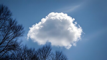 Wall Mural - a solitary cloud floating in the deep - blue sky, natural color balance