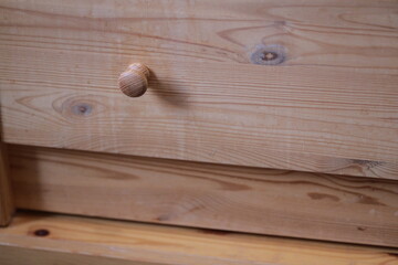 Aufkleber - A close-up shot of a wooden drawer with a traditional knob.