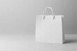 © Marina Demidiuk - White Paper Pouch. Paper bag standing on a light background. Delivery and shopping concept. Disposable eco recycled kraft packaging template mockup. Empty shopping bag for branding or advertising.