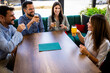 © Mediteraneo - Group of friends met at the restaurant. They hang out, drink beer and laugh.