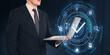 © Who is Danny - Businessman holding laptop with holographic checkmark icon and technology interface.