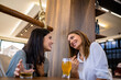 © Mediteraneo - Two girl best friends having out at the restaurant. Drinking coffee and orange juice. They gossip, laugh and have fun time.
