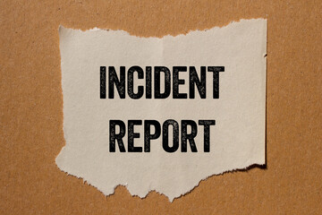 incident report message written on ripped torn paper piece on brown background. conceptual incident 