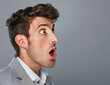 © Milla - Businessman in a suit with a shocked expression and wide-open eyes and mouth, profile