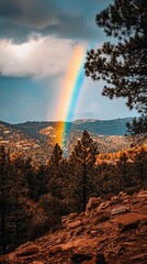 Wall Mural - Majestic rainbow arching over autumnal mountain landscape.