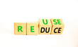 © Dzmitry - Reuse or reduce symbol. Concept words Reuse Reduce on wooden block. Beautiful white table white background. Business reuse or reduce concept. Copy space.