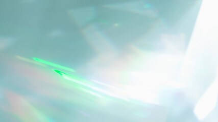 Wall Mural - Rainbow Rays of Light in a Prism. Loop. The optical lens system creates a series of bright, changing geometric highlights on a light surface