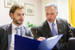 © Minerva Studio - Two businessmen discussing documents at office