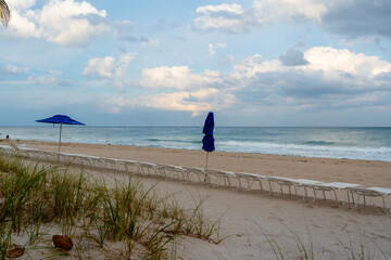 Wall Mural - lounging chairs on beach with ocean