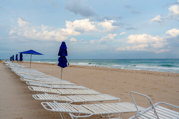 Wall Mural - lounging chairs on beach with ocean