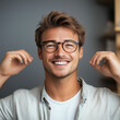 © Mikael - Happy Young Man Wearing Glasses Smiling Indoors
