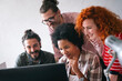 © NDABCREATIVITY - Group of business people and software developers working as a team in office