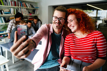 Canvas Print - Self-portrait of excited happy cheerful startup business people having fun in office during meeting