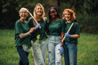 © Zamrznuti tonovi - Four volunteers smiling and holding gardening tools