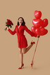 © Pixel-Shot - Happy young woman with bouquet of roses and heart shaped air balloons on brown background