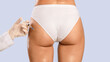 © Prostock-studio - Non-Sugical Butt Lifting Sculptra Concept. Rear back view of young lady getting hip injection at beauty salon, closeup cropped. Surgeon making injection at buttocks area, isolated on studio background