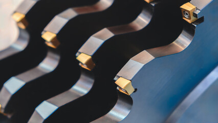 Aufkleber - A row of metal milling cutters with a blue tint. The tools are arranged in a line and appear to be the same size.