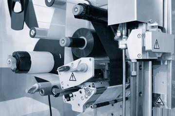 Poster - Fragment of the conveyor of sticking labeling machine. Abstract industrial background.