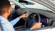 © Prostock-studio - Black Man Choosing New Car In Auto Salon, African American Male Customer Sitting Inside Of Automobile And Touching Multimedia Screen While Purchasing Vehicle In Modern Dealership Center, Closeup