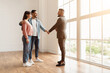 © Prostock-studio - Sealing A Deal. Millennial Couple Buying New Apartment, Husband Hugging Wife And Shaking Hands With Professional Real Estate Agent. Smiling Manager In Suit Selling Flat To Happy Young Family