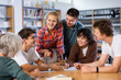 © JackF - Group portrait of smiling young teenage children working together in public library