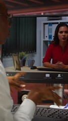 Poster - Vertical video Remote employee in teleconference meeting with manager, answering inquiries. Friendly freelancer in home office sitting at desk in front of computer screen, greeting supervisor in