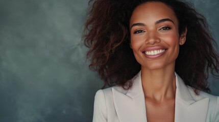 Wall Mural - Portrait of a beautiful African American black businesswoman in a white suit against a neutral background