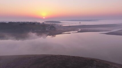 Wall Mural - Sunrise fog over the lake, migratory birds in winter