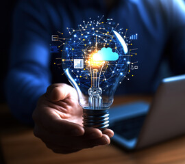 Poster - A hand holds a glowing light bulb, symbolizing innovative ideas and technology.